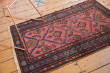 Vintage Lilihan rug corner: sky blue border, dusty rose field, serrated herati leaf motifs.