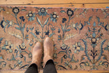 Antique Kerman fragment runner with boots, showing vinery, floral palmettes, and soft beige, blue tones.