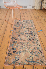 Elongated vinery, floral blossoms, and hand-bound selvage on antique Kerman rug in blues and beige.