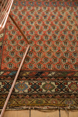 Antique Hamadan rug with madder root red boteh field, multi-toned border, and end tatter.