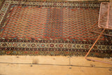 Antique Hamadan rug with allover boteh, madder red field, pronounced abrash, and intricate borders.