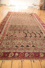 Lower border of antique Karabagh carpet with time-softened wine red and pale ivory paisley motifs.