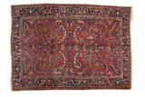 Vintage Persian Heriz rug, cherry red field, classic serrated leaf design, navy border.