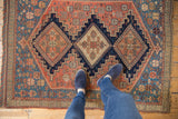 Late 19th century Persian Afshar rug featuring indigo, blush, and detailed geometric floral patterns.