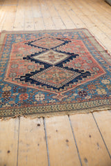 Fine antique Persian Afshar rug's weave, detailing germinating plants in dusty blush and indigo.