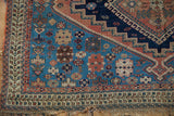Antique Afshar rug's lower left corner: unique checkered boteh motif, dense geometric patterns, and fringe.