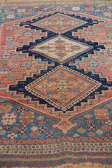 Stepped contours and intricate patterns on an antique Afshar rug, in blush and calming blues.