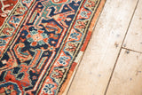 Polychrome side cord selvage detail of Heriz carpet, cherry red, navy blue, and teal patterns.