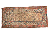 Vintage hand-knotted Kurdish runner featuring camel ground, repeating plant motif, madder red and sky blue borders.