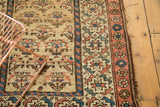 Vintage Kurdish rug border with madder red, camel, blue geometric design and tattered edge.