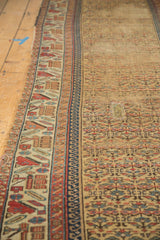 Detail of antique Kurdish runner showing germinating plants, geometric borders, and an older patchwork.