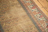 Antique Kurdish runner showing germinating plants, latch motif, and exposed foundation.