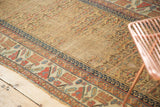 Antique Kurdish runner detail: dusty gold germinating plants, red, blue latch motif, visible wear.