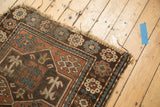 Distressed corner of an Avar style Caucasian rug, showing geometric borders and crab motifs.
