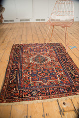 Vintage Karaja rug corner, with cream fringe, geometric border, and brick red field.
