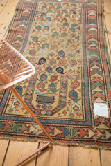 Antique Caucasian Prayer rug's mehrab with comb design, boteh field, and visible hole.