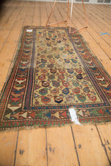 Tattered end, large hole, and Laleh Abassi pawn border of antique Caucasian prayer rug.