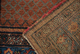 Hand-knotted Hamadan rug reverse, showing precise foundation weave and reddish-pink side selvage.