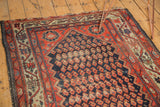 Worn madder root red vine border, navy blue boteh field of an antique Hamadan.