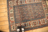 Antique Kurdish Bijar rug with faded allover boteh pattern on indigo, showing foundation wear.