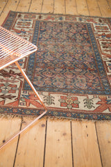 Antique Kurdish Bijar rug corner, showing hard wear, tattered fringe, indigo, and madder red.