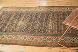 Antique Kurdish runner, allover henna plant motif in navy, red, and visible foundation.