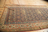 Kurdish runner corner detail: madder red, sky blue, celadon borders and tattered fringe.