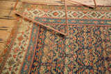 Antique Kurdish runner corner with tattered ends, visible foundation wear, and henna plant motif.