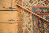 Antique Kurdish runner's tattered side, showcasing foundation weave with madder root red and neutral tones.