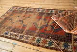Antique Caucasian rug with extensive foundation wear, dusty brick red, and navy blue pawn motifs.