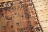 Textured wear, exposed foundation, and tattered fringe on the antique Caucasian rug.