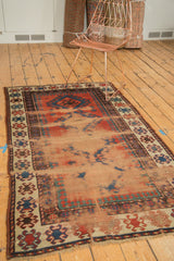 Etched foundation of antique Caucasian rug, showing brick red field and navy blue geometric motifs.