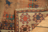 Antique Caucasian rug showing hand knotted foundation texture and geometric hook and latch pattern.