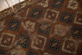 Antique Yomud rug detail: bronze-teal geometric allover panel design, historical patina.