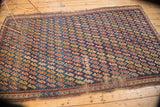 Collector antique Caucasian rug corner: wear, tatter, geometric serpent design in indigo and red.