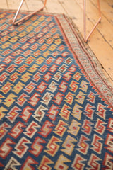 Simplistic serpent lattice motif in indigo, madder red, saffron yellow antique Caucasian rug.