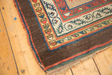 Antique Serab runner corner: rich aubergine outer border, ivory, red, and blue geometric motifs.