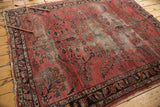 Antique Lilihan rug with dusty raspberry field, intricate floral vinery, and visible pile wear.