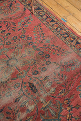 Intricate floral vinery of a Persian Lilihan rug with time-softened raspberry and blue tones.