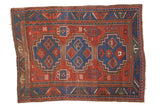 Antique Caucasian rug, circa 1910s, with triple blue geometric medallions on a cherry red field.