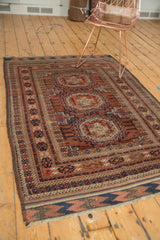 Antique Belouch rug corner: chevron kilim end with fringe, in copper, navy, and ivory.