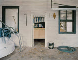 Joe Farrell's photograph of a garage interior with white walls and a tan car framed in a doorway.