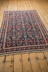End of an Antique Mahal rug, showing aged macram and slightly tattered fringe.