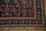 Antique Mahal rug corner: Herati pattern, indigo, madder red, powder blue selvage, tattered fringe.