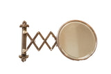Antique beveled glass accordion shaving mirror, fleur de lis mount, aged patina, white accents.