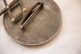 Close-up of the vintage mirror's aged metal back with visible stamped manufacturer text.