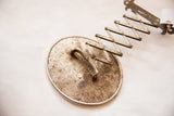 Back of the oval antique shaving mirror showing aged rust and discoloration on metal.