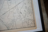 Aged brown-toned edge of the vintage map showing a slight curl and white matting.