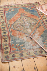 Vintage Oushak rug with distressed pile, exposed foundation, faded rust corner, floral border.