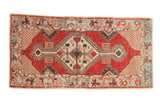 Distressed Oushak runner with cherry red diamond medallion, geometric ivory finials, pale blue border, 2'8